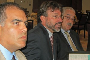 Economist Vicente Feliciano (center) discusses the results of MIDA's latest industry study.