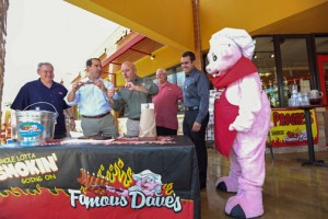 Famous Dave's executives Steve Pierce, Jorge Colón-Gerena, Abelardo Ruiz, Paat Naughton, Alex Lignos during Wednesday's meet-and-greet. Wilbur, the chain's mascot, looks on.