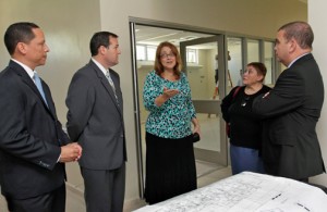 Banco Popular and RIncón Health Center executives walk through the future health facility.