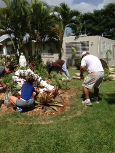 Volunteers work on the landscaping at the Hogar de Niñas home in Cupey.