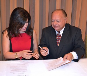 SBA District Director Yvette T. Collazo and INTENE Executive President Edgardo Agrait sign the strategic alliance agreement.