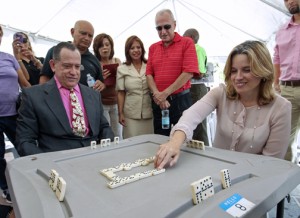 San Juan Mayor Carmen Yulín Cruz tries her hand at dominoes, going against XXX. 