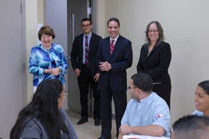 National University College President Gloria Baquero (right, blue shirt) leads a walk-through of the new faclities.