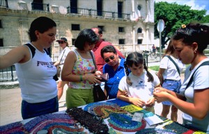 Tourists with euros and convertible pesos browse through necklaces, beads and other trinkets at the hard currency crafts market in Old Havana. By the end of 2014, Cuba's dual-currency system will begin to be dismantled. (Credit: Larry Luxner)