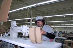 An unidentified employee works on one of the items to be produced at Raine's new Mayagüez operations.