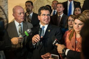 Flanked by NPP lawmakers, Resident Commissioner Pedro Pierluisi reacts following the State of the Commonwealth address.