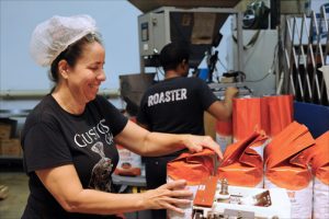 Maybelline Fermaint-Torres packages Casa Grande coffee at the Gustos Coffee Co. production facility in Guaynabo. (Credit: Larry Luxner)